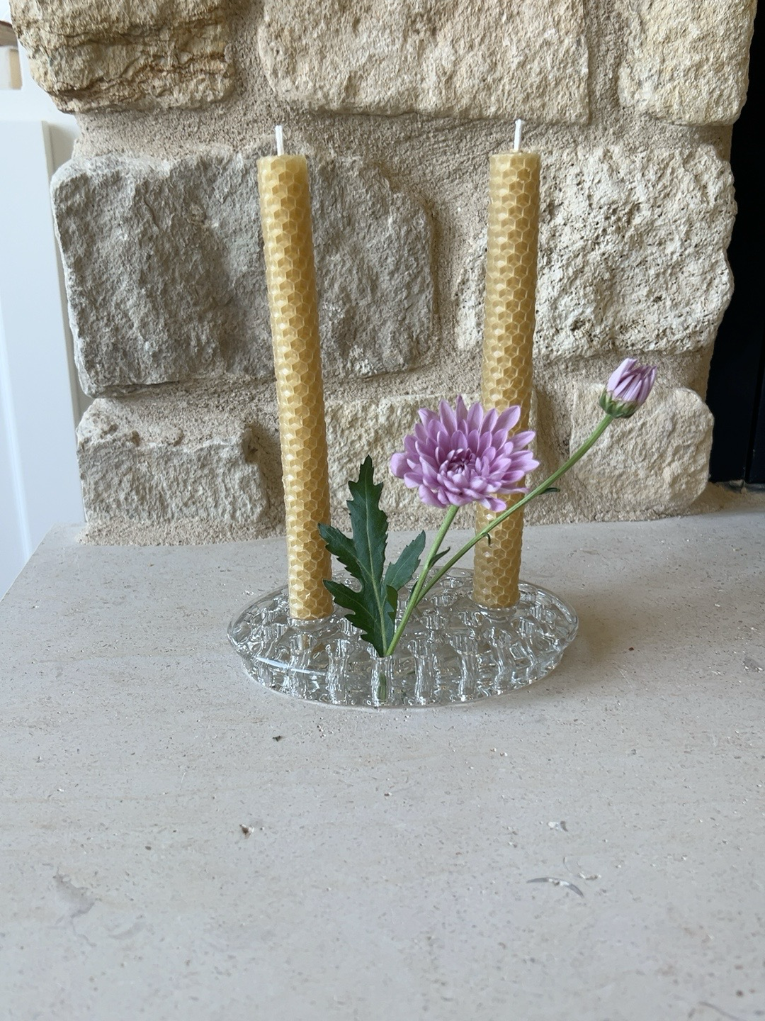 Oval clear pressed glass flower frog with two candle sockets, beeswax tapers, purple chrysanthemum