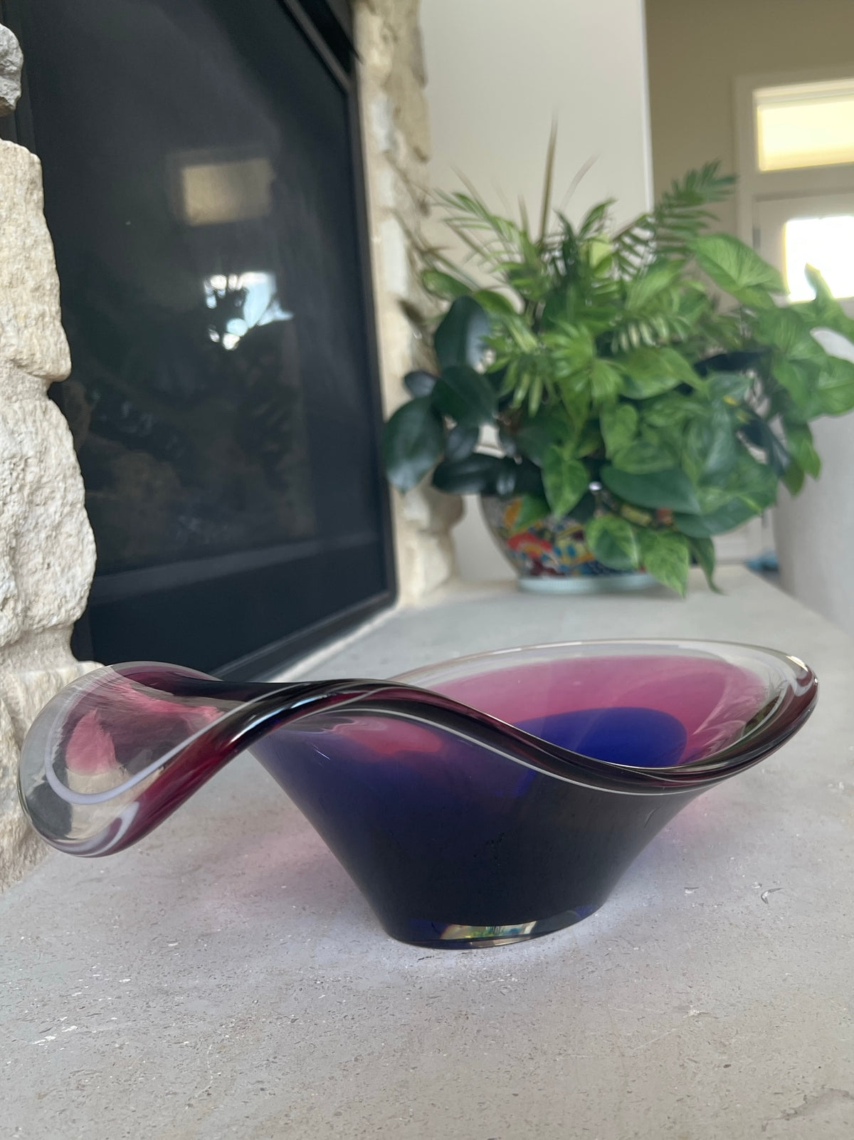 Vintage Flygsfors art glass bowl with sweeping pink rim and deep cobalt blue interior.