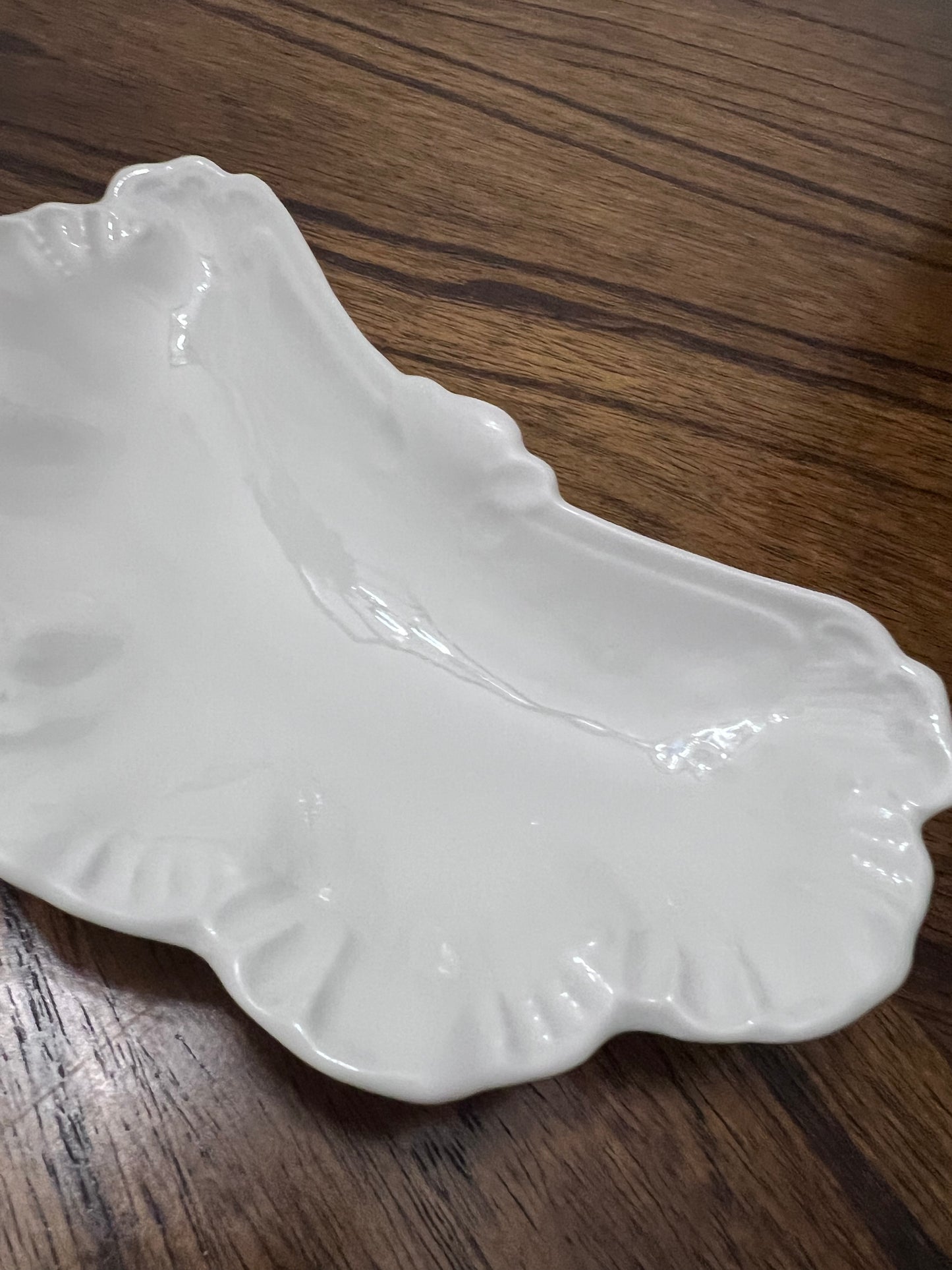 A. Lanternier Limoges bone plate, France c. 1891–1914, white crescent form with scalloped rim