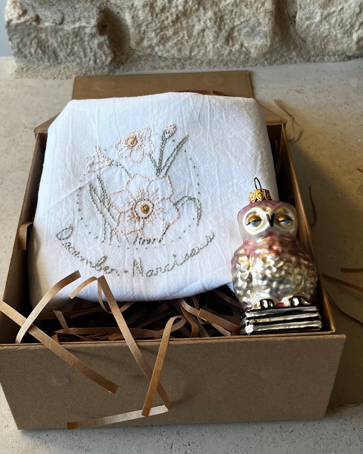 Hand-embroidered narcissus tea towel with Polish glass owl ornament in kraft gift box