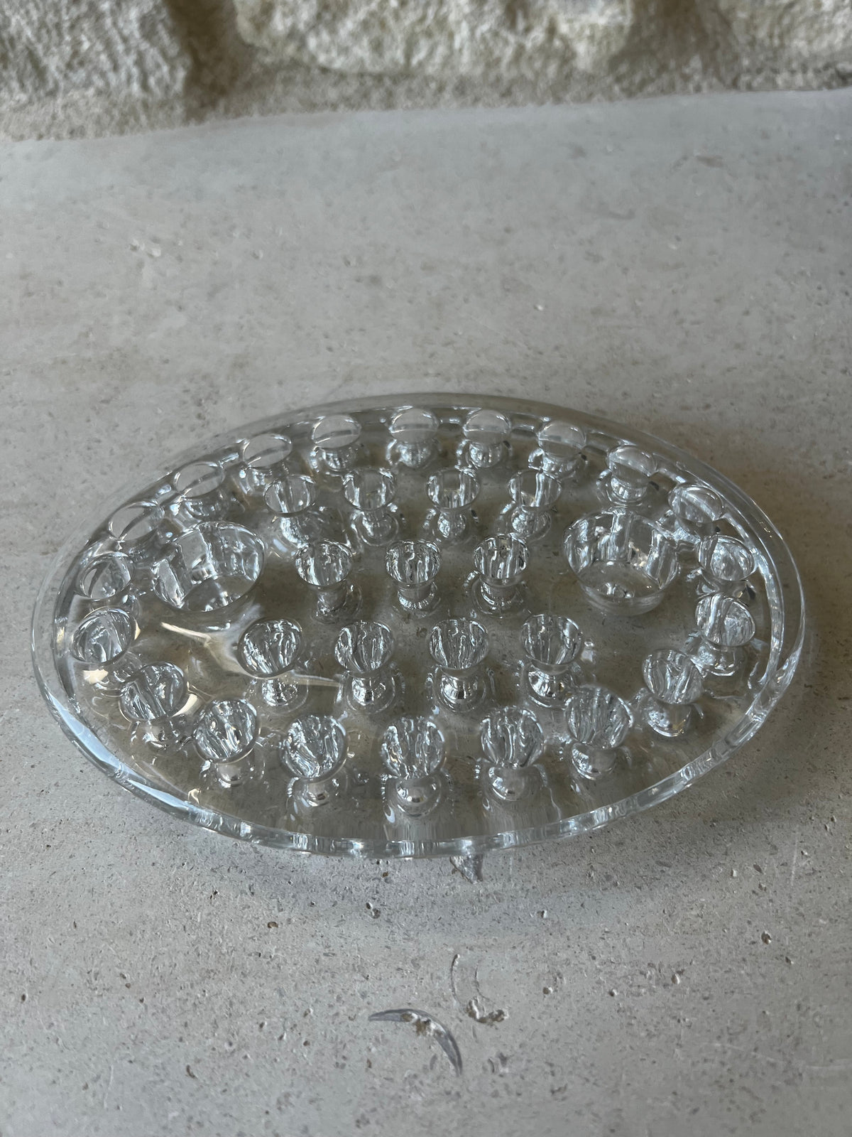 Oval clear pressed glass flower frog, rows of stem holes, two raised candle sockets