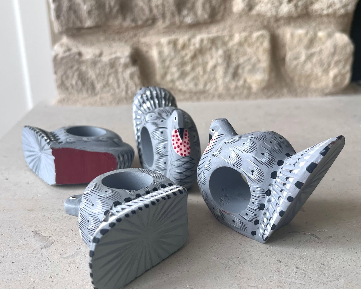 View of wooden turkey napkin rings showing painted details, surface marks, and areas of paint wear. 