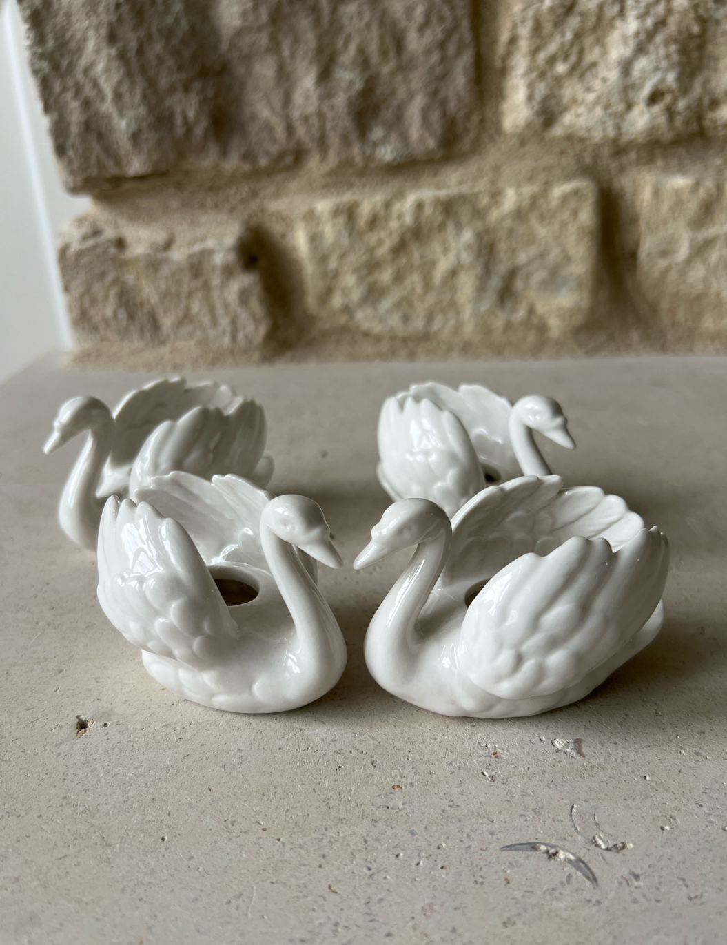 Goebel white porcelain swan taper holders, pair, glazed sculpted feather detail, side view