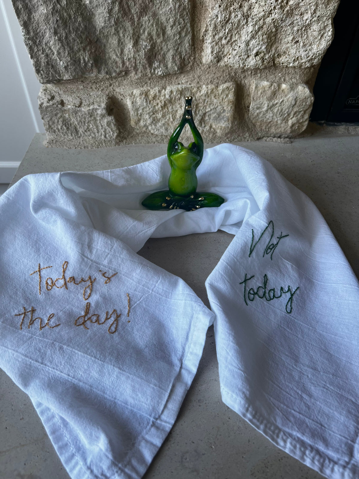 Hand-embroidered cotton flour sack towel, "Today's the day!" gold, "Not today" green, resin yoga frog ring holder
