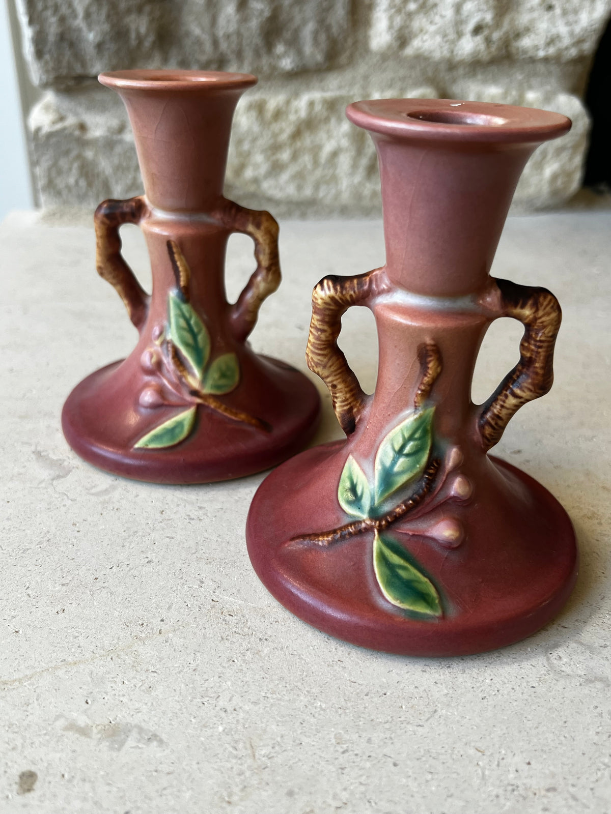 Roseville Apple Blossom candlesticks showing branch handles and botanical decoration