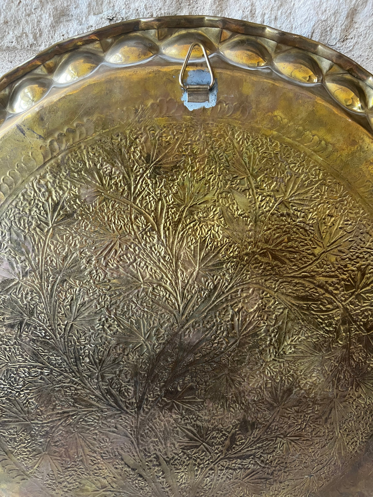 Reverse of brass tray showing hanging hook, unmarked.