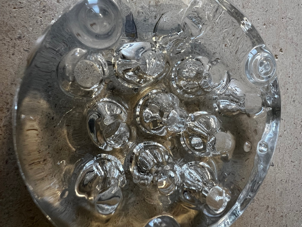 Close-up of clear pressed glass flower frog, ring of molded stem holes