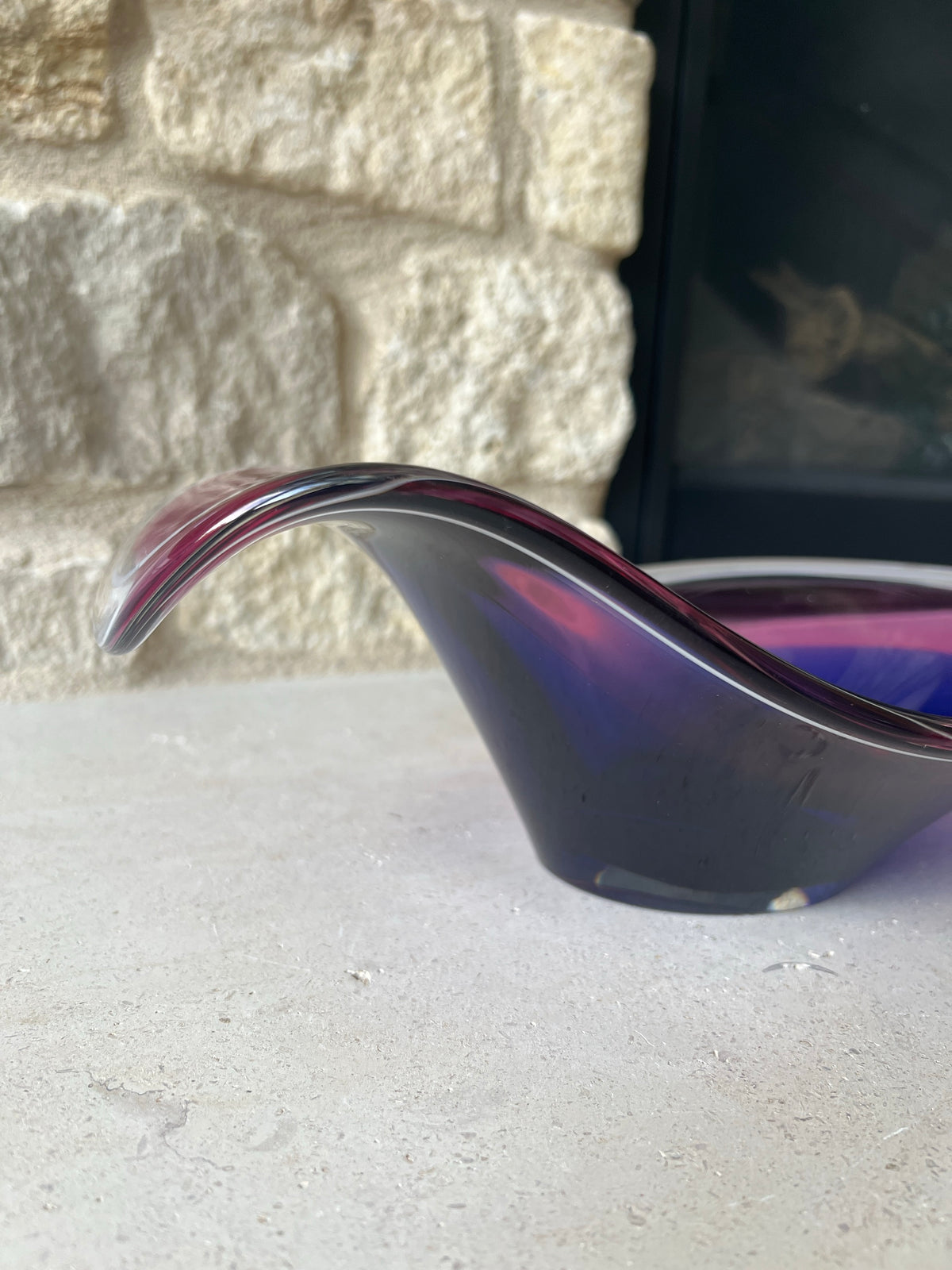 Side profile of Flygsfors art glass bowl showing its sculptural raised rim. 