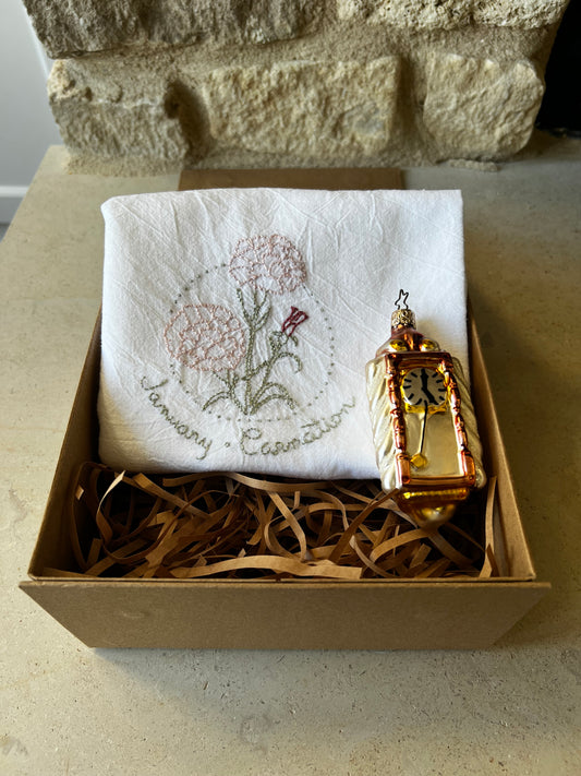 Hand-embroidered carnation tea towel with W. Germany glass clock ornament in kraft gift box