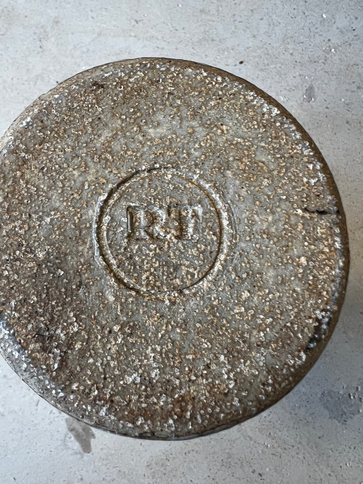 Unglazed speckled stoneware base impressed with circular RT maker's stamp