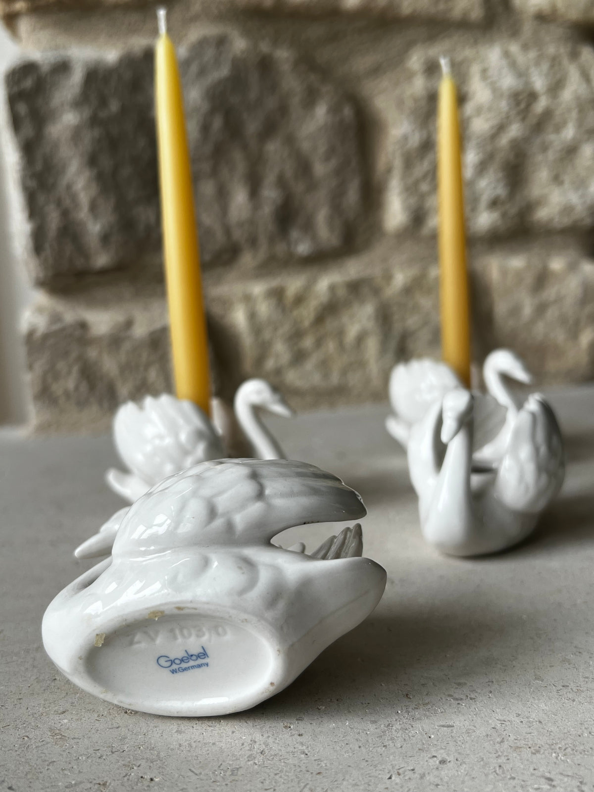 Goebel white porcelain swan taper holder tipped on side, blue underglaze maker's mark on base. West Germany 
