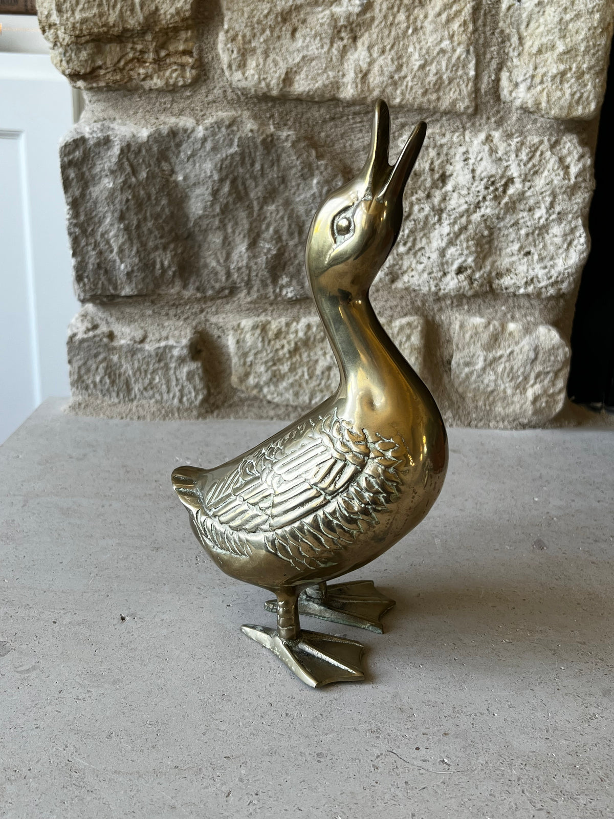 Vintage brass goose sculpture showing opposite side and detailed feathers